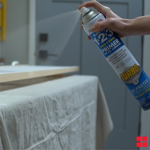 Spraying Zinsser Bulls Eye 1-2-3 Primer on shutters.