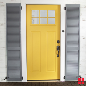 Gray shutters around yellow front door.